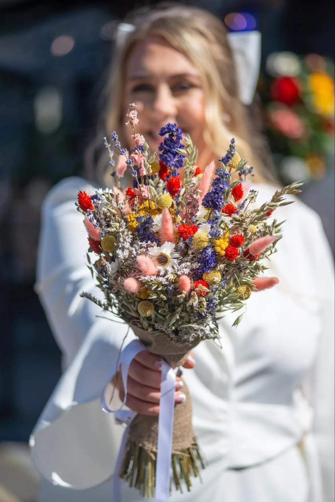 Bride holding a dried flower bouquet from our colourful Cottage Garden Collection.