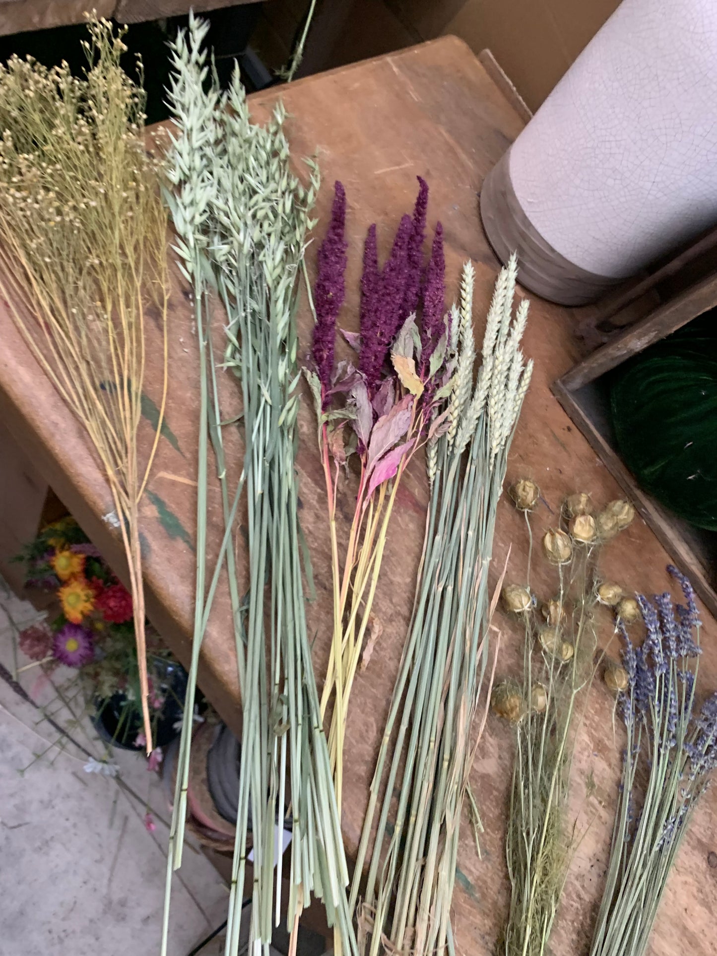 Dried flowers, seadheads and grasses on a wooden surface