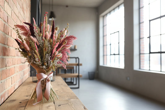 Dusky Pinks Dried Flower Bouquet on a wood shelf in a bright loft style apartment