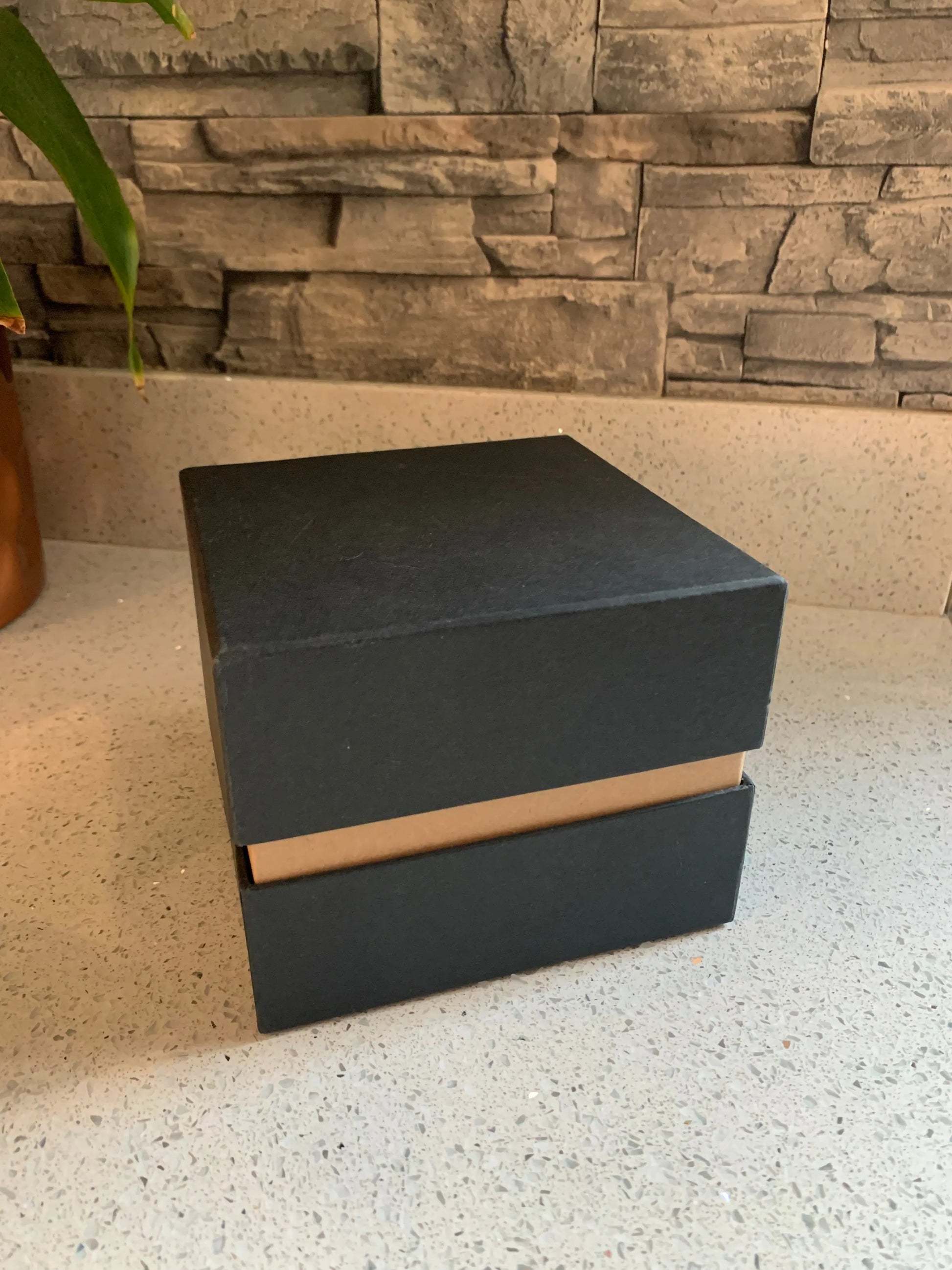 A black gift box on white granite surface
